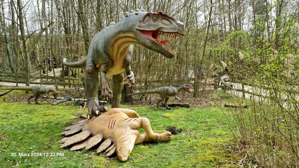 Ein riesiger Raubdinosauriere vor seiner Jagdbeute, ein Stegosaurus